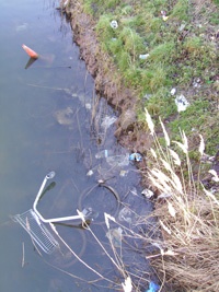 Fly-tipping in a stream